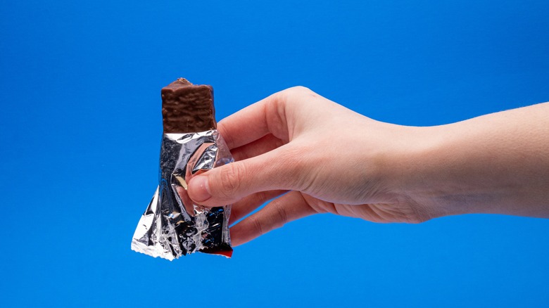 hand holding protein bar in wrapepr