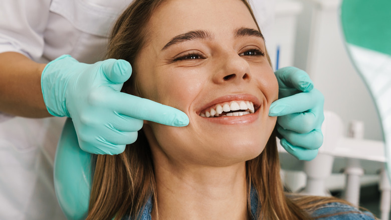 Woman having teeth examined