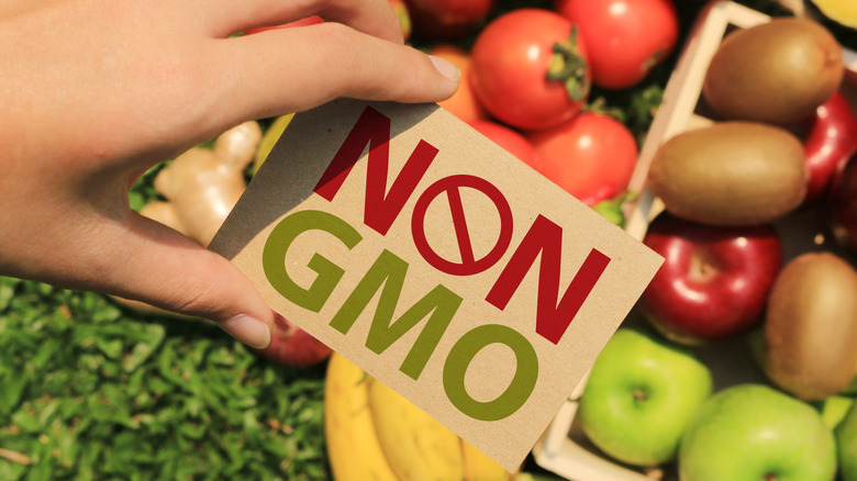 Non GMO sign in front of fruits