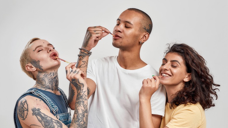 young people enjoying gummy worms