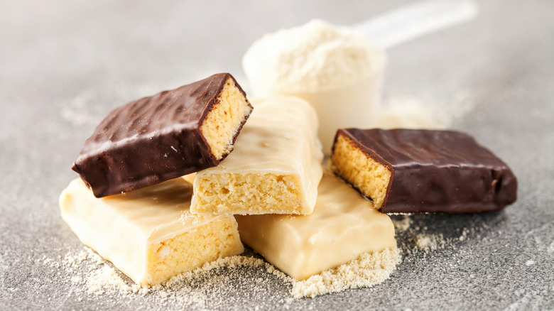 Protein bars and protein powder on a table