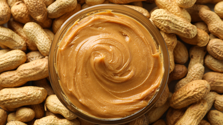 Peanuts and jar of peanut butter