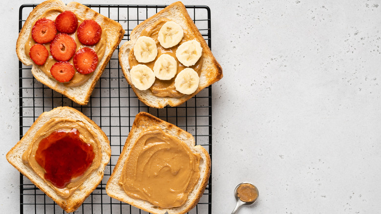 open faced peanut butter sandwiches with fruit and jelly