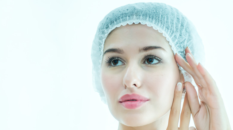 Woman putting on shower cap