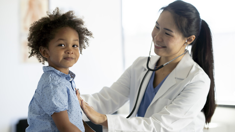 Doctor examining child patient