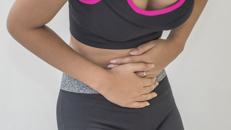 Fit woman having stomach pain