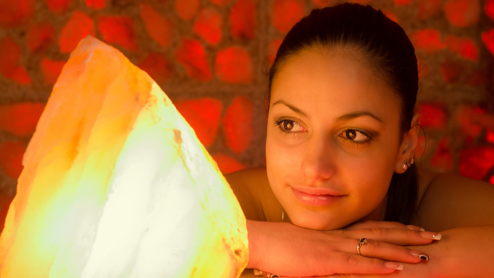 Woman enjoying the glow of a Salt lamp