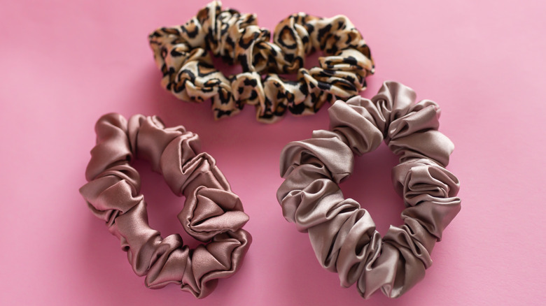 3 hair scrunchie accessories on a pink background