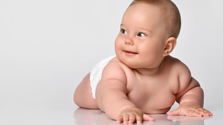 smiling baby in white diaper