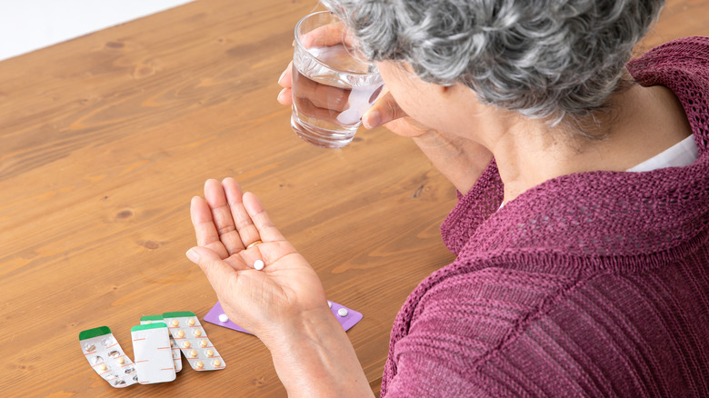 elderly woman taking medication