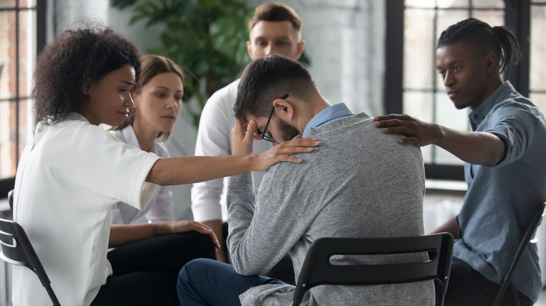 grieving man comforted in support group