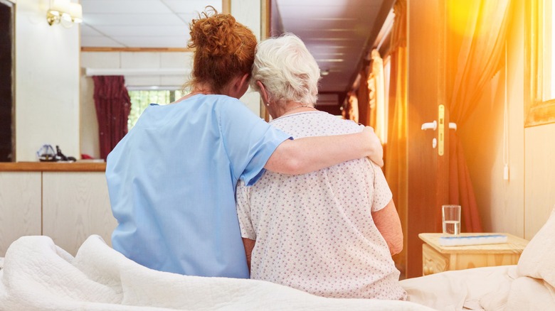 nurse comforting grieving woman