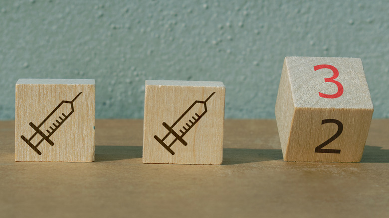 3 wooden blocks with syringe symbols and numbers