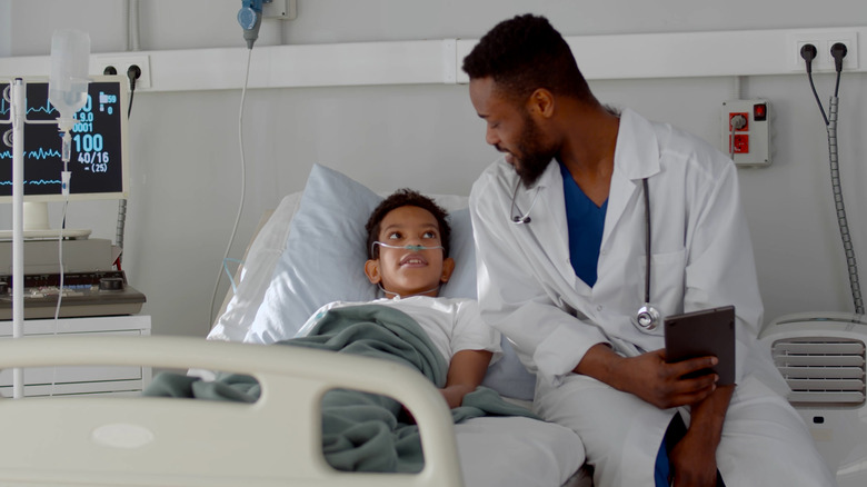 Doctor speaking with child hospital patient