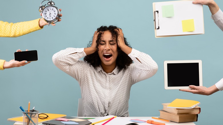 overwhelmed woman surrounded by tasks concept