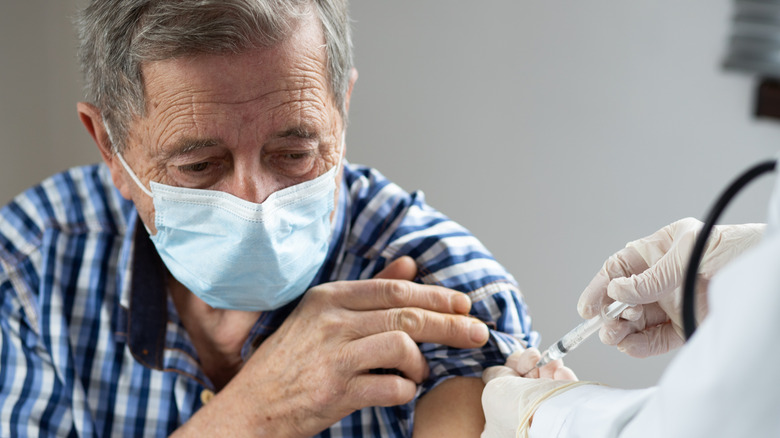 elderly man getting covid shot