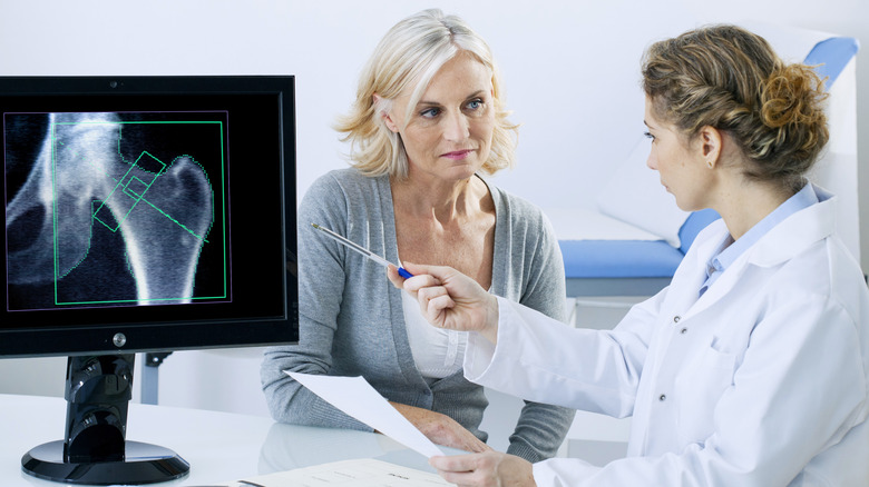 Doctor discussing bone X-ray with patient