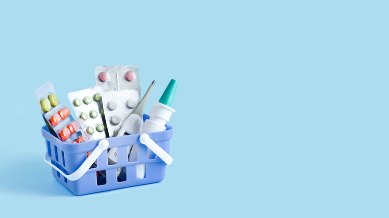 small basket of different medications on light blue background