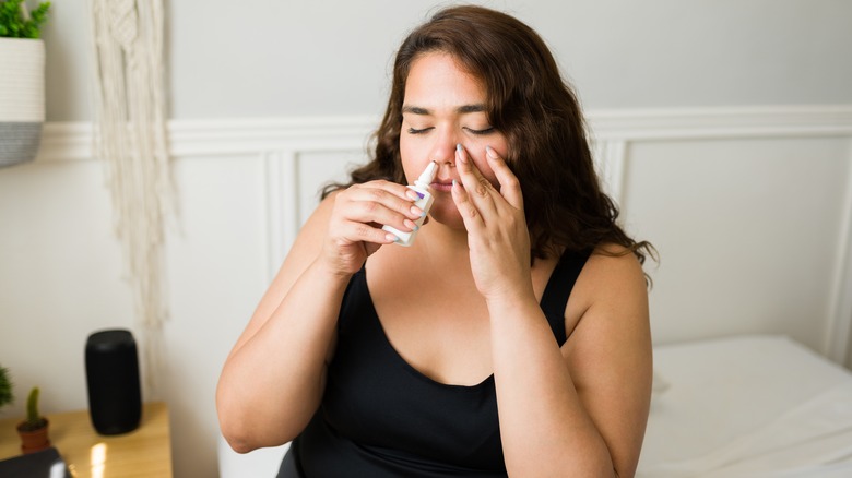 Woman using allergy nasal spray