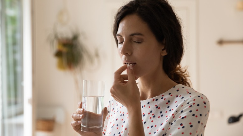 woman taking medications