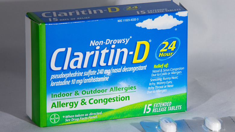 box of 24 hour Claritin D with pill package lying on gray background