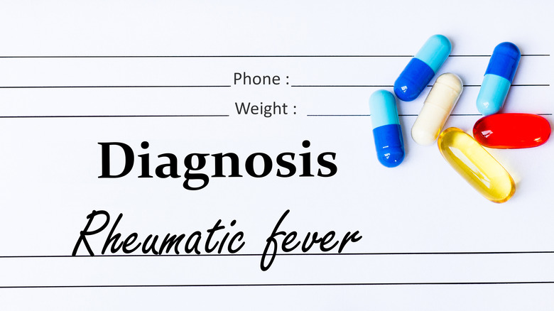 rheumatic fever diagnosis written on white paper with medication on paper