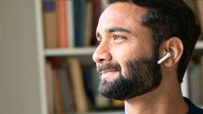Man with earbud in ear
