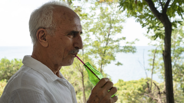 Man sipping soda through a straw