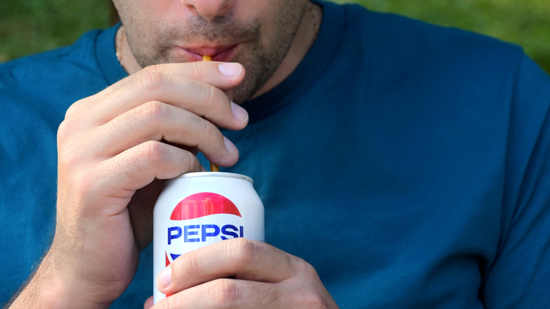 man drinking sugary drink