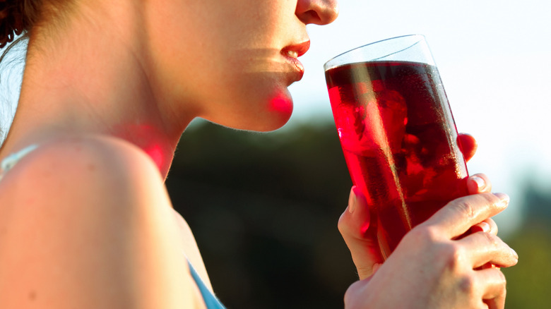 Woman enjoying glass of cranberry juice