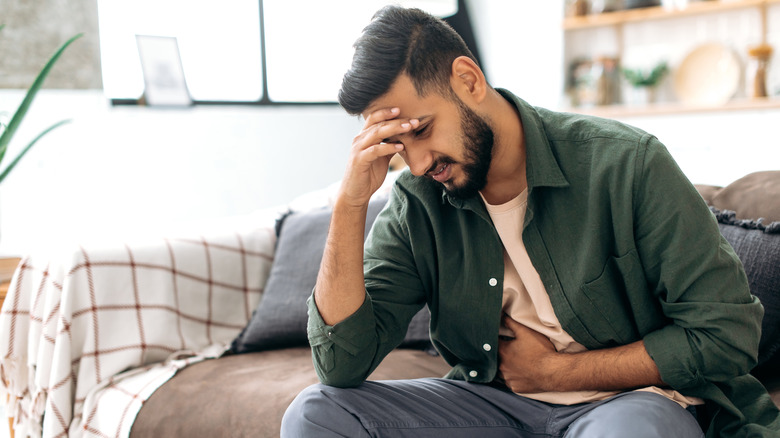 Man holding stomach in pain