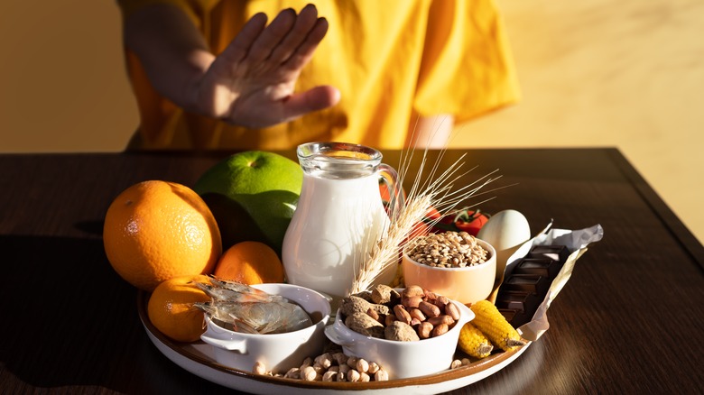 woman declining plate of peanuts