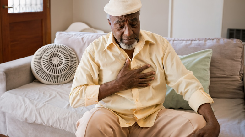 Man placing hand on his chest