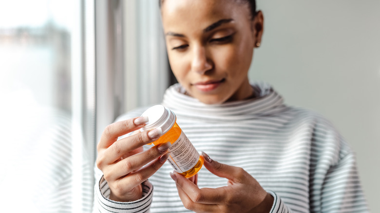 Woman reading prescription drug label