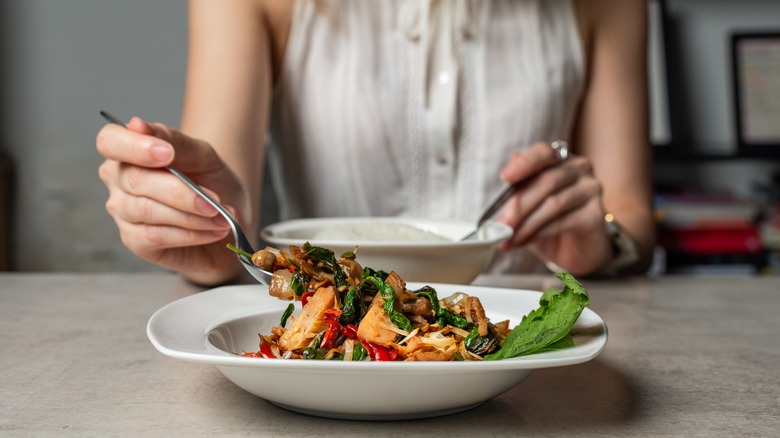 Woman eating spicy Thai food