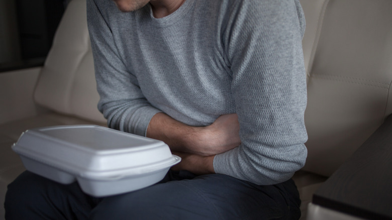 Man holding stomach in pain