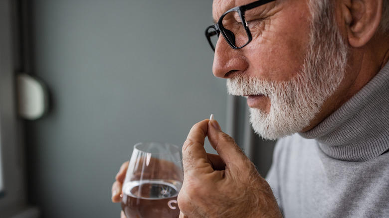 Older man taking medication