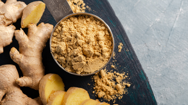 powdered ginger and ginger root on a plate