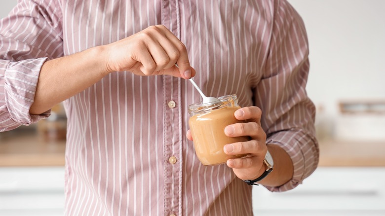 Man eating peanut butter