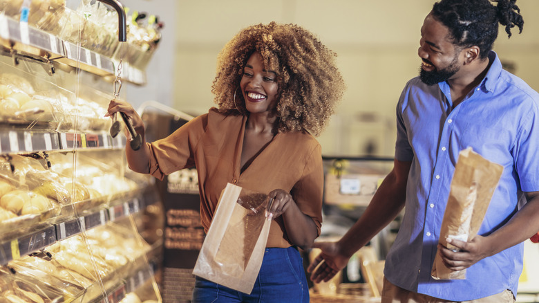 Smiling couple shopping for bread