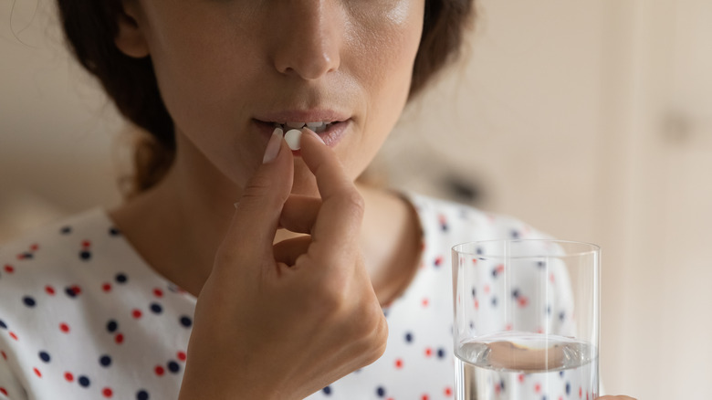 woman taking ibuprofen