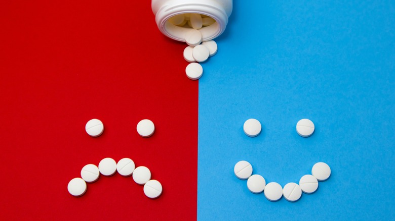 Happy and sad smileys made of pills