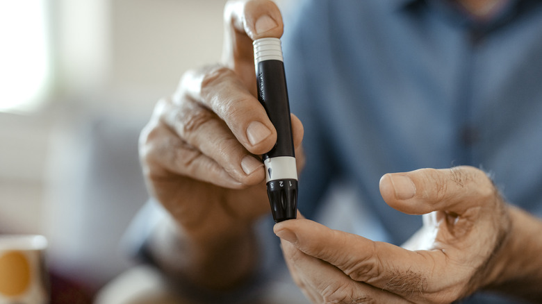 Man measuring his blood sugar levels