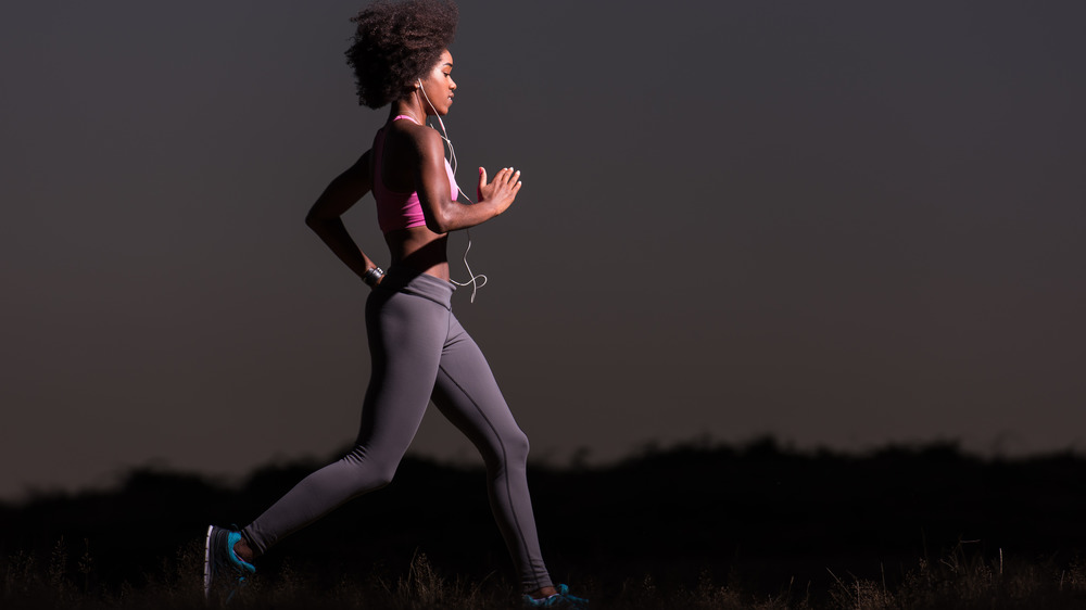 young woman running at night