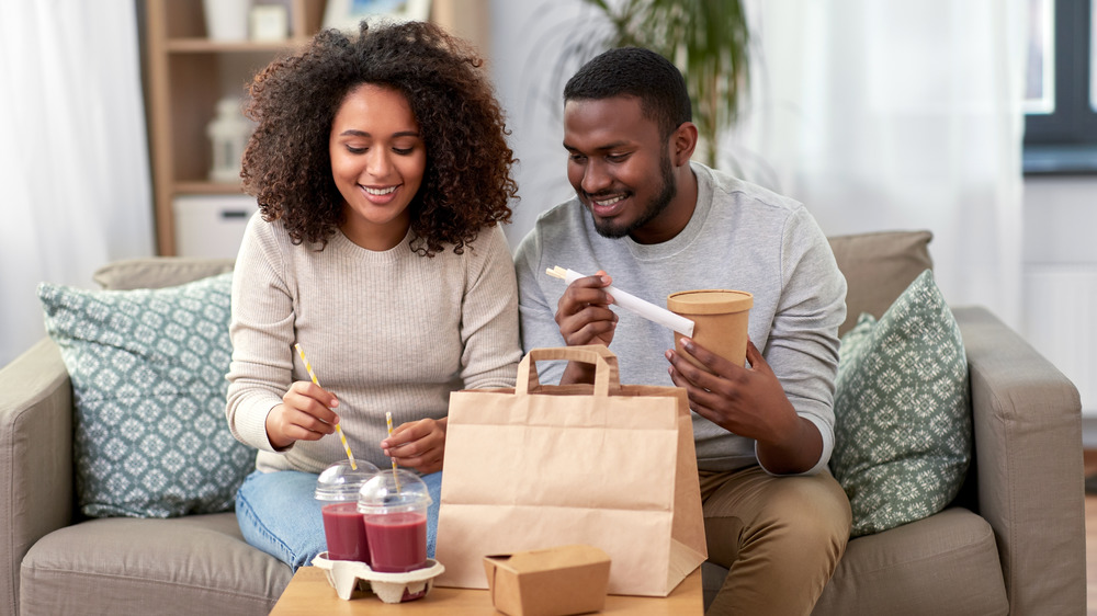 Couple eating takeout meal