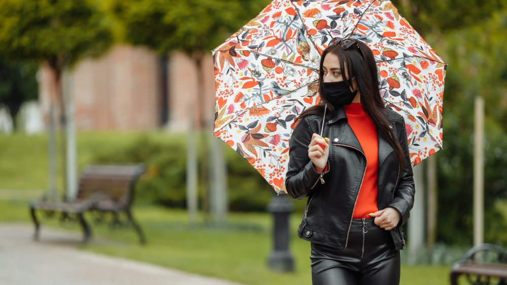 woman in mask in the rain