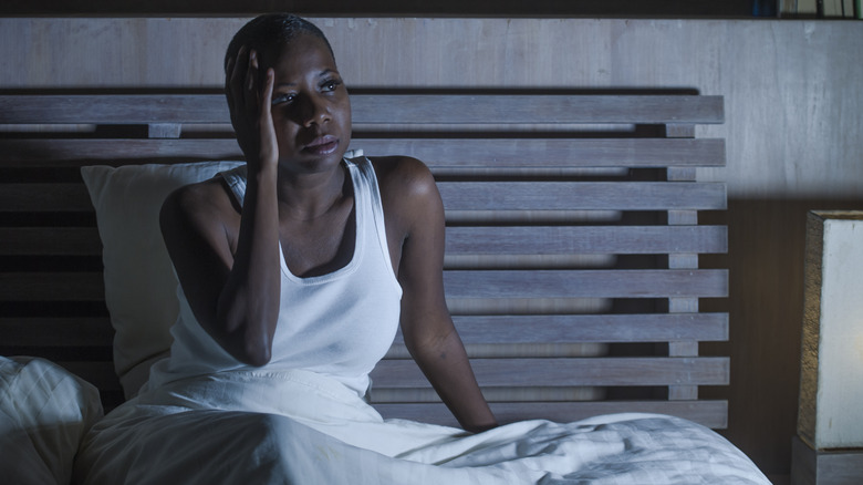 Frustrated woman awake in bed
