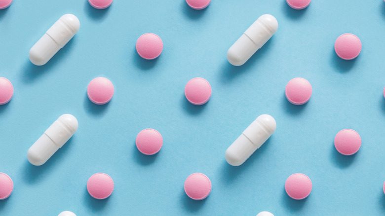 pink and white pills on a blue background