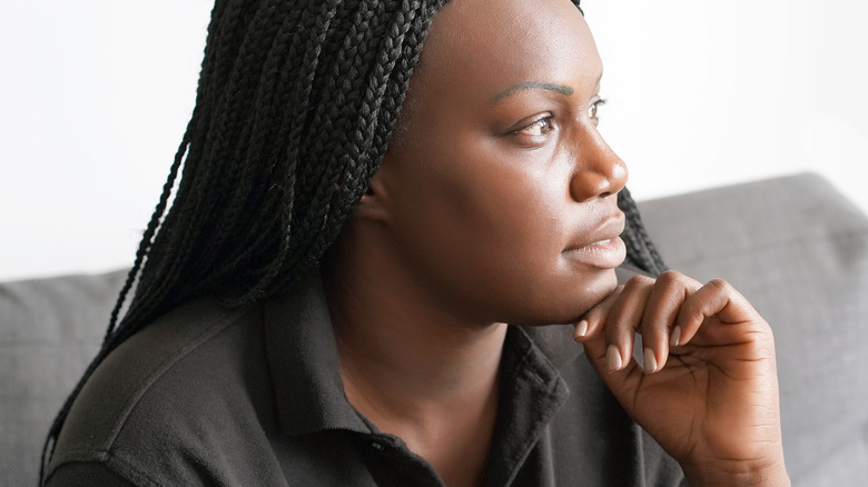 sad woman thinking on couch