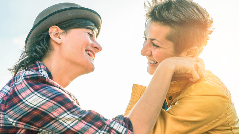 Laughing couple holding hands